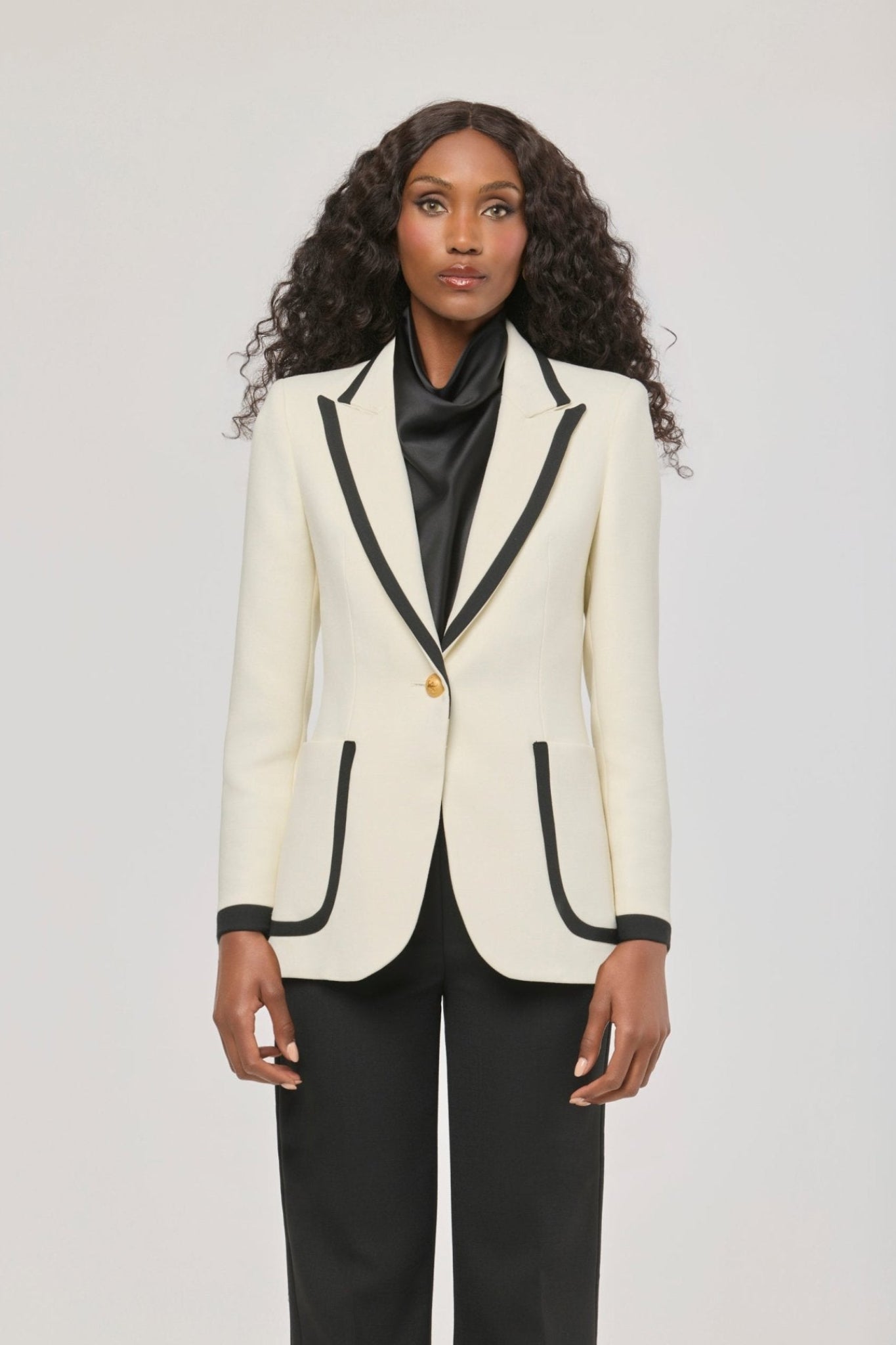 Blazer blanco con ribetes en contraste Laurent de The Extreme Collection en impecable blanco con vivos negros y sofisticados botones dorados.