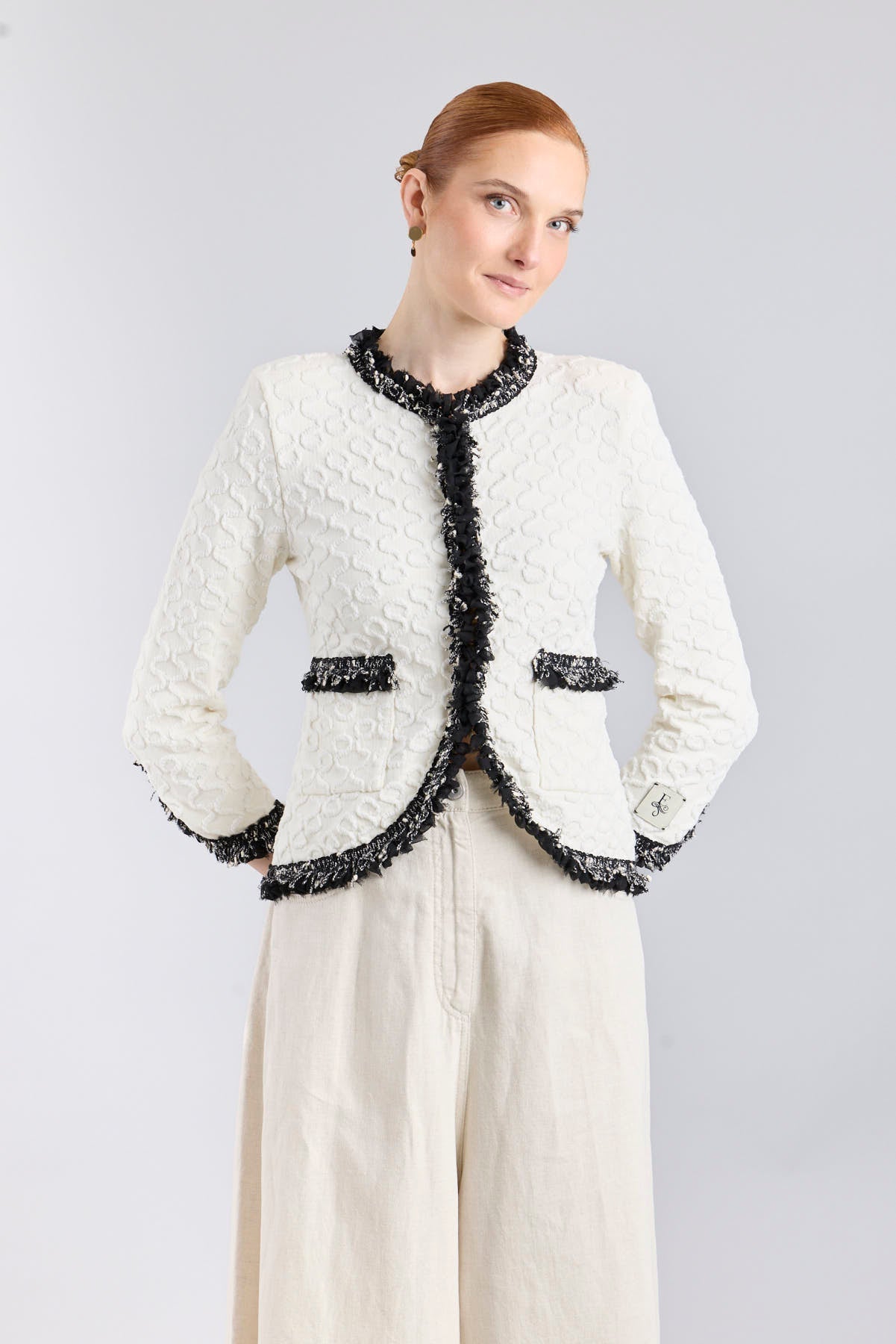 Chaqueta de lujo blanca para mujer modelo Ludovica con ribetes oscuros y detalles brillantes.